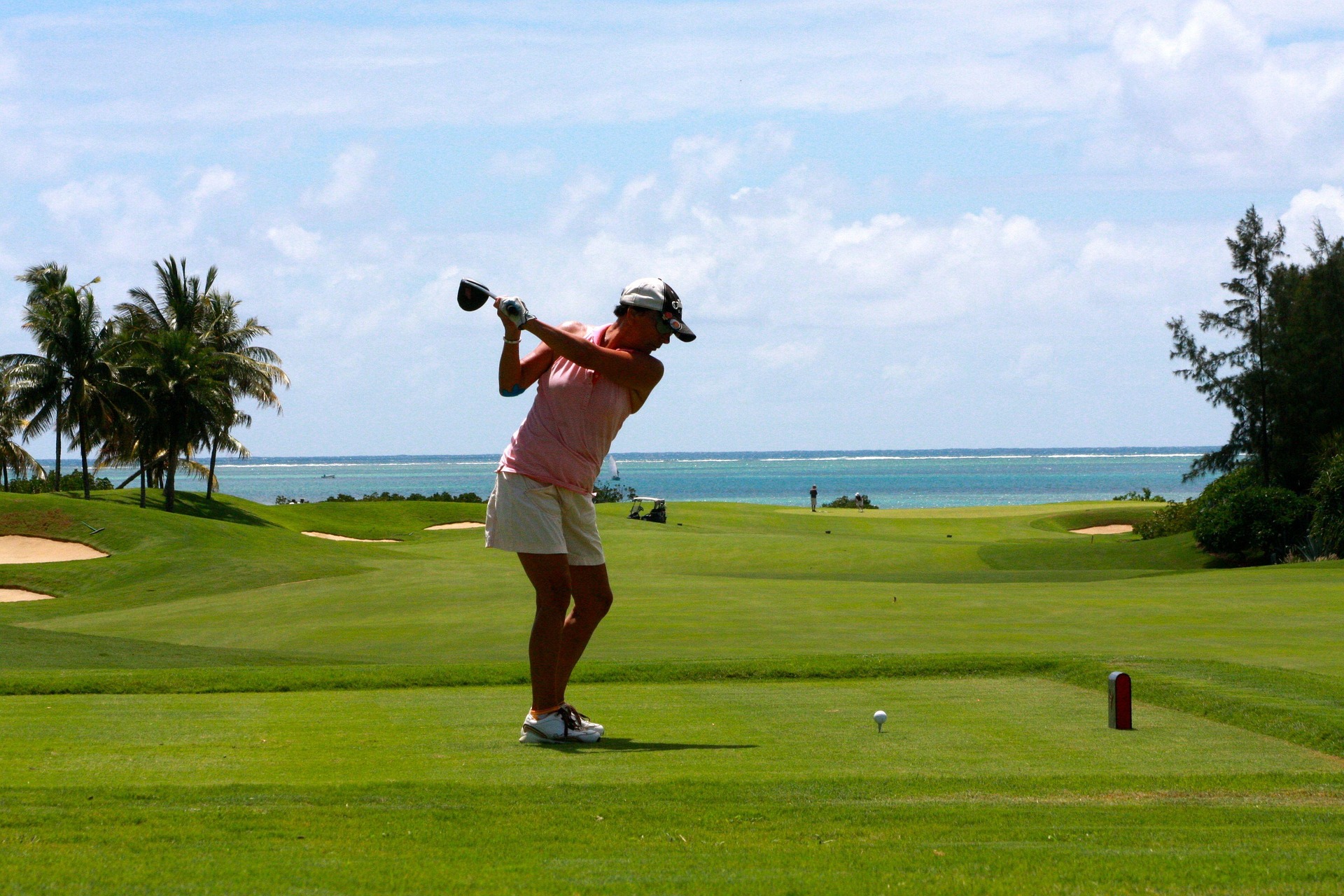 Golfer wearing Golf House apparel on the tee box